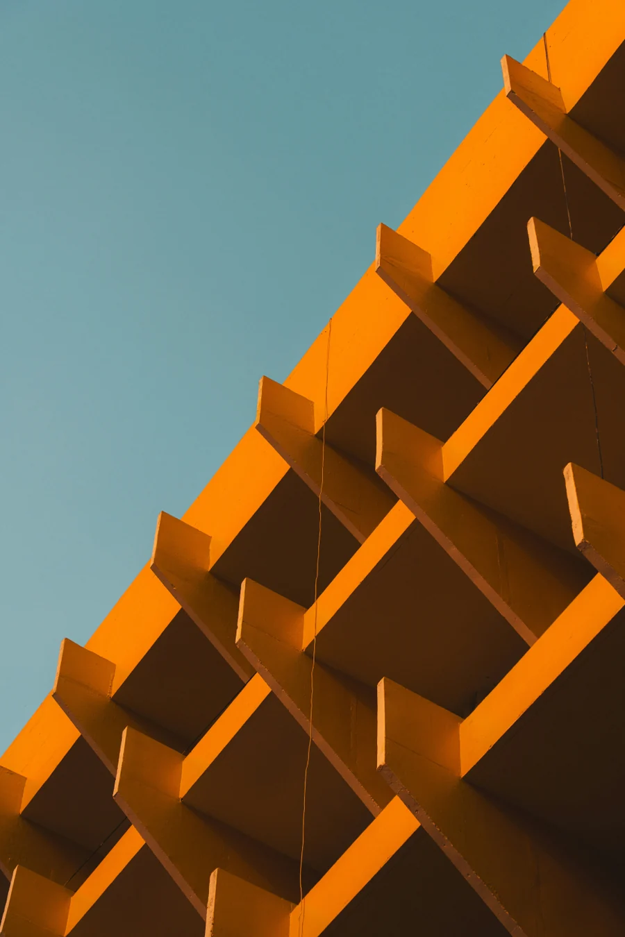 Orange concrete façade against a blue sky
